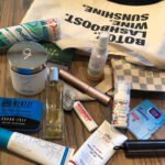 Skincare products next to purse 